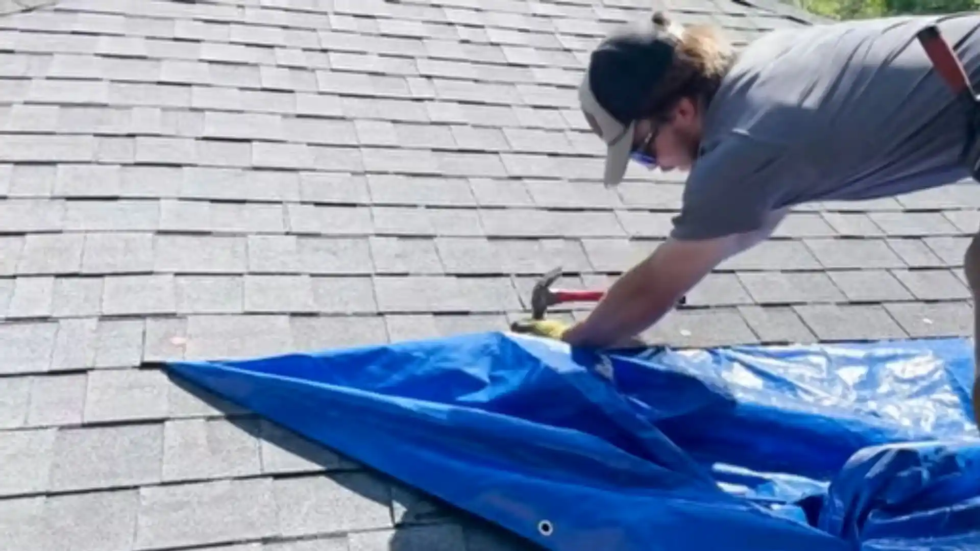 Storm-damaged roof with emergency tarp in Montgomery Village, MD